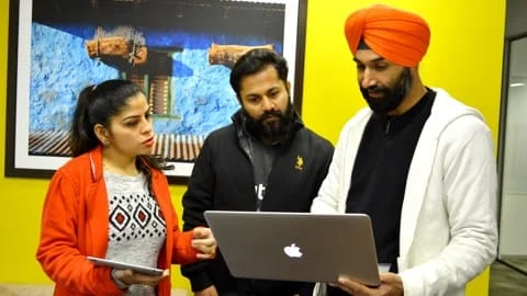 Net Solutions employees collaborating on an iOS product | Mobile app development services