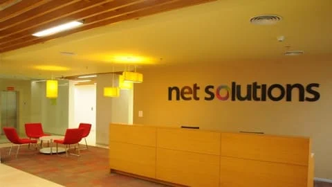Net Solutions office space with red chairs | Mobile app development services
