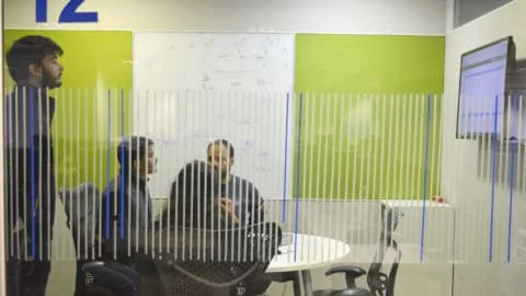 Net Solutions employees collaborating on a development project in an office